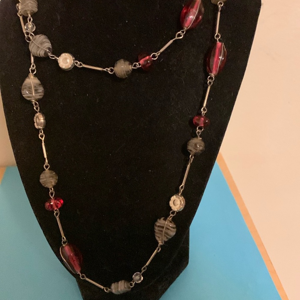 Gorgeous red and grey beads grace this silver necklace 38”
